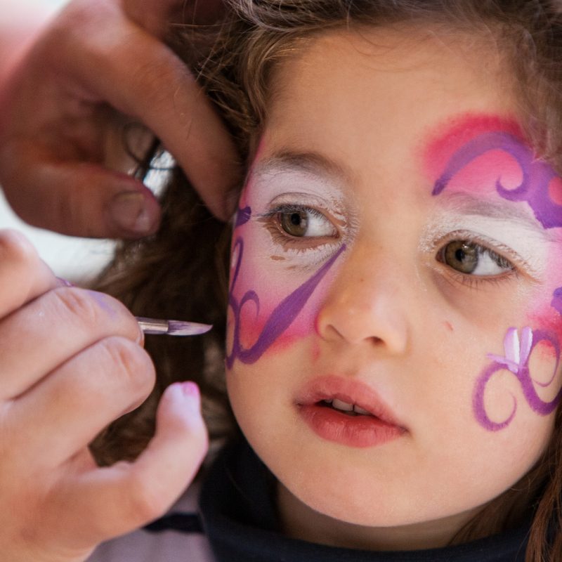 A girl has her face painted in California, USA