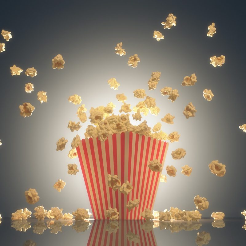 Popcorn exploding out of the striped package. Clipping path included.