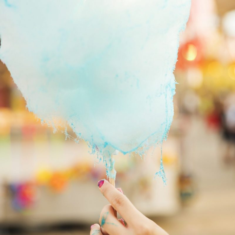 woman-s-hand-holding-candy-floss